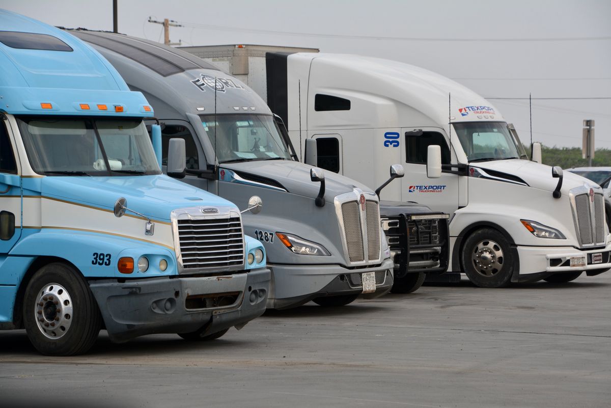 Row of semi trucks lined up and ready to roll